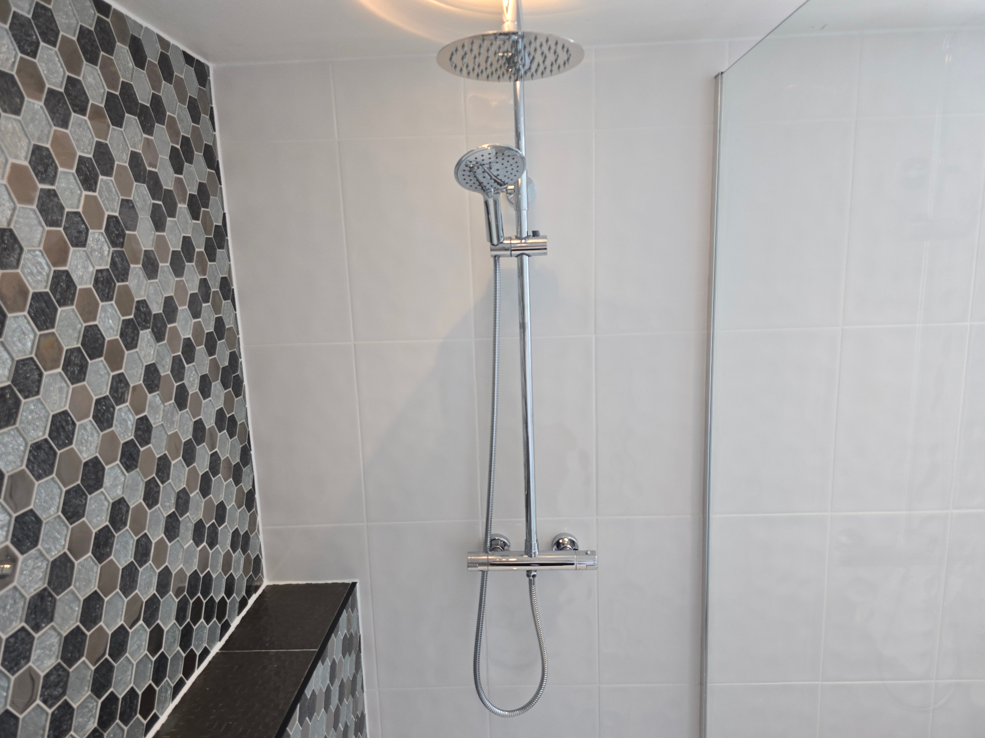 Chrome shower riser bar installation in a Tamworth bathroom