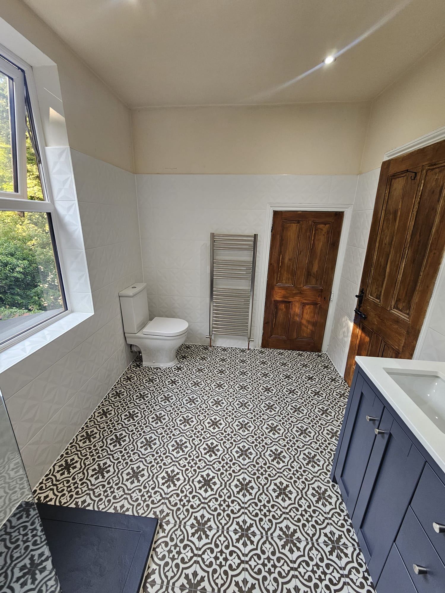 Bathroom with WC, heated towel rail and patterned non-slip floor tiles in Tamworth