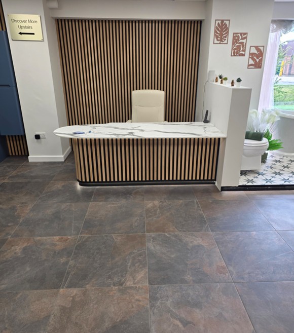 Reception desk with calacatta marble worktop and timber slat panelling at the Tamworth bathroom showroom